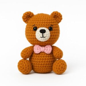 handmade crochet teddy bear with pink bow | knitted soft plush bear toy for babies, kids & nursery décor | cute handmade gift for baby shower & birthday